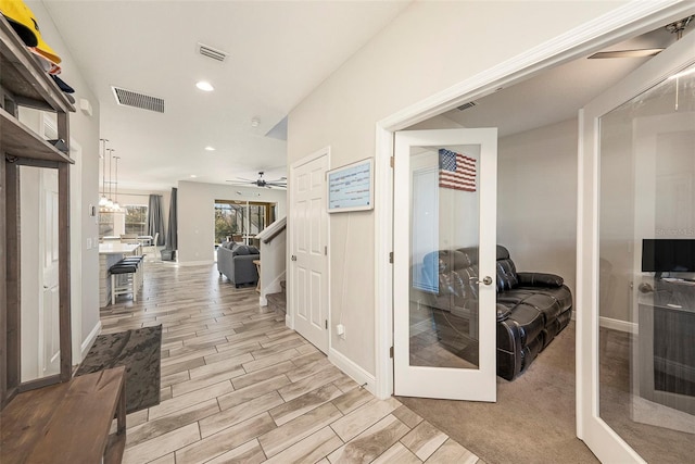 hallway with wood tiled floor, visible vents, french doors, and recessed lighting