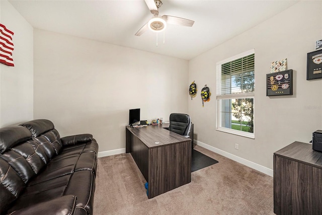 office area with baseboards, a ceiling fan, and light colored carpet