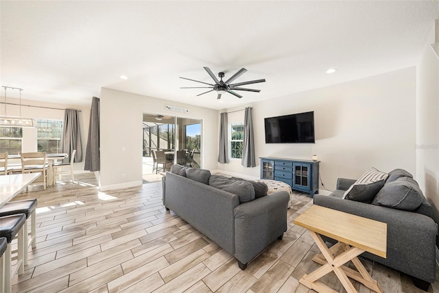 living area with wood tiled floor, baseboards, a ceiling fan, and recessed lighting