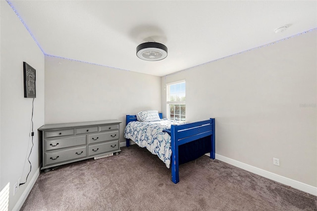 carpeted bedroom featuring baseboards