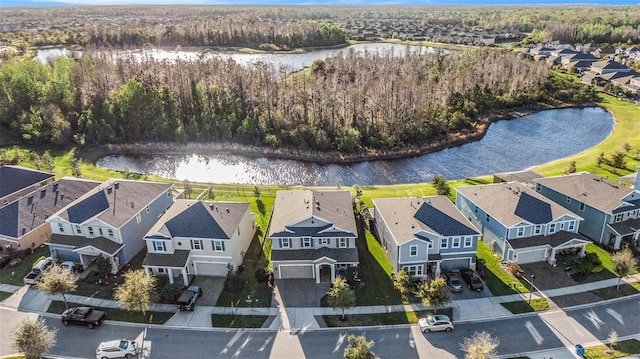 aerial view with a residential view, a water view, and a wooded view