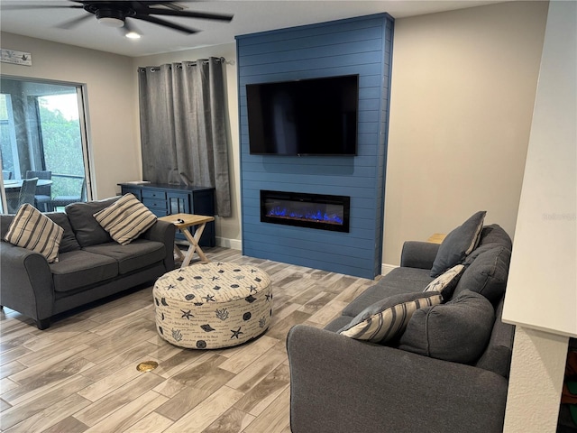 4607 Ballantrae Blvd, Land O Lakes, FL 34638 - living area with a ceiling fan, light wood-style flooring, and a fireplace