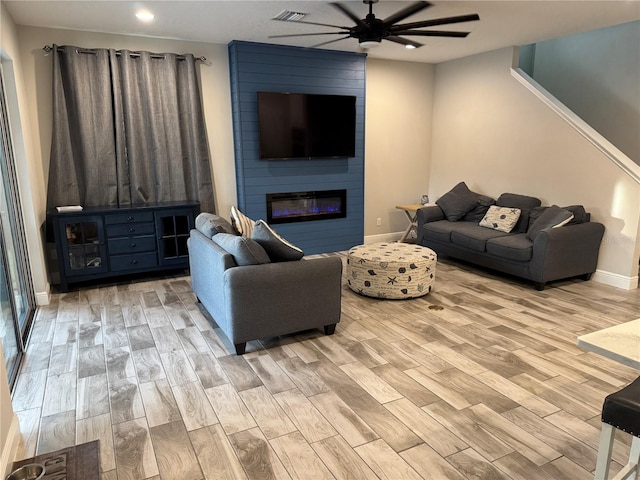 4607 Ballantrae Blvd, Land O Lakes, FL 34638 - living room with ceiling fan, wood finished floors, recessed lighting, and a large fireplace