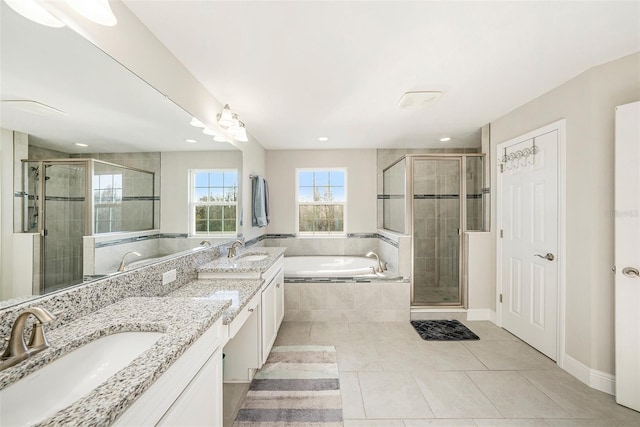 4607 Ballantrae Blvd, Land O Lakes, FL 34638 - bathroom with double vanity, tile patterned floors, a garden tub, a shower stall, and recessed lighting