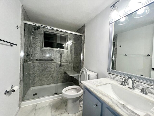 bathroom with a stall shower, marble finish floor, vanity, and toilet