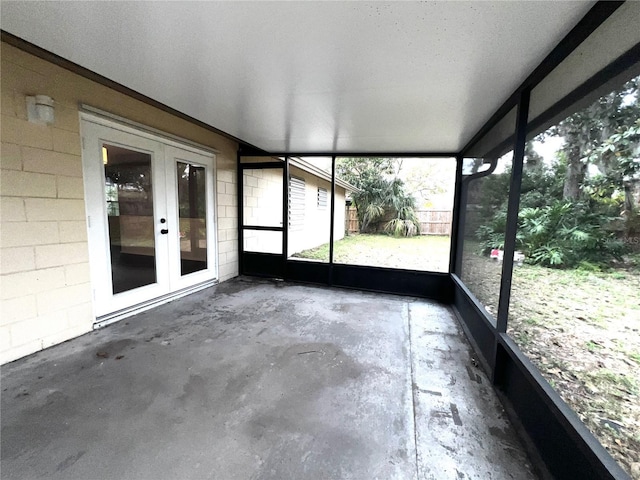 unfurnished sunroom with french doors