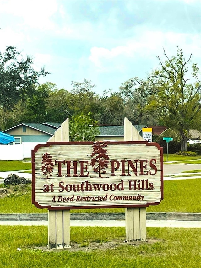 community / neighborhood sign featuring a yard