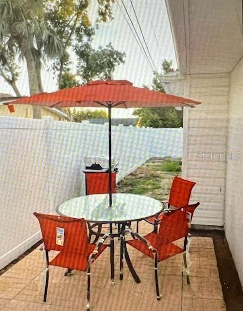 view of patio / terrace featuring fence and outdoor dining area