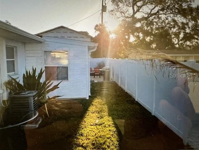 view of side of property featuring fence