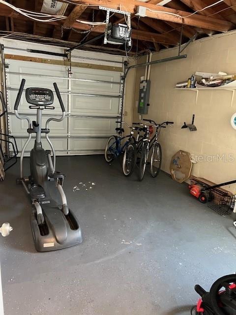 garage with electric panel and a garage door opener