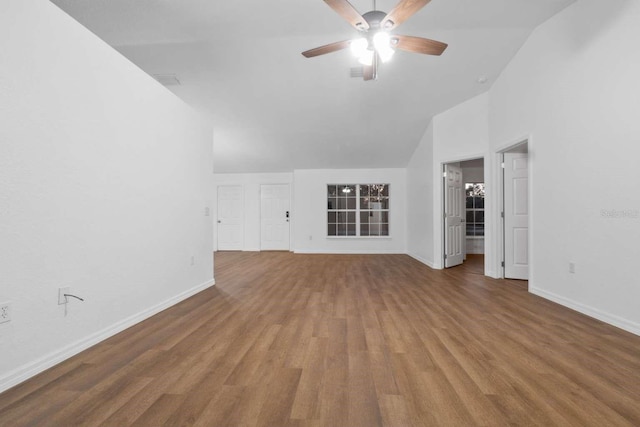 unfurnished living room with high vaulted ceiling, wood finished floors, a ceiling fan, and baseboards