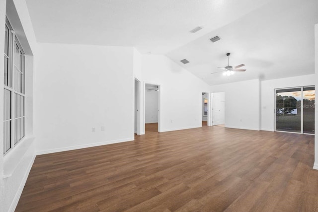 interior space featuring vaulted ceiling, wood finished floors, a ceiling fan, and baseboards