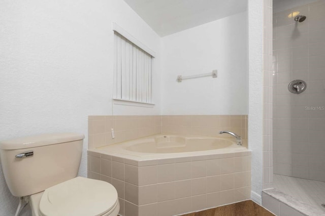 full bathroom with a garden tub, a tile shower, toilet, and wood finished floors