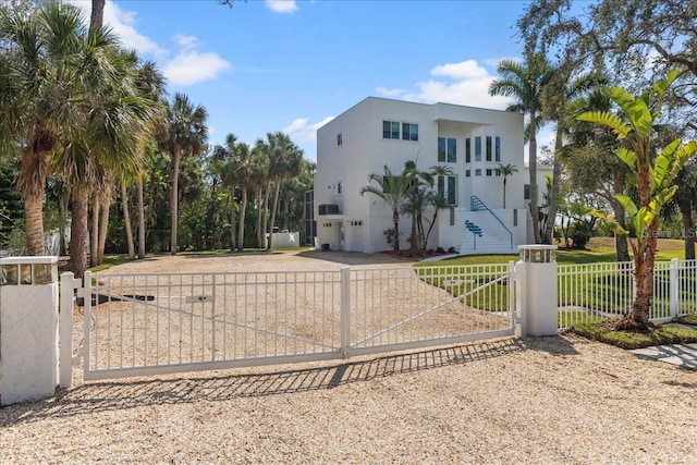 view of gate featuring a fenced front yard and a yard