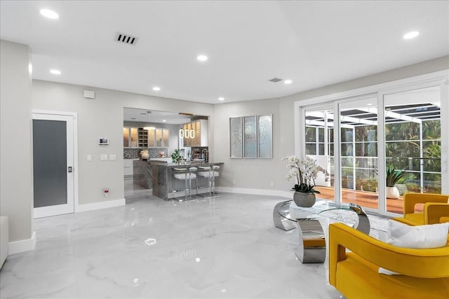 living room with recessed lighting, visible vents, baseboards, and marble finish floor