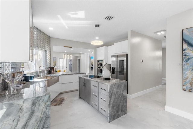 kitchen featuring white cabinets, modern cabinets, visible vents, and stainless steel appliances