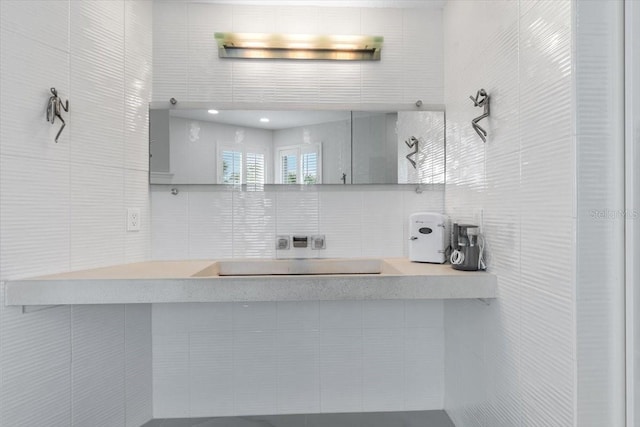 bathroom with decorative backsplash and tile walls