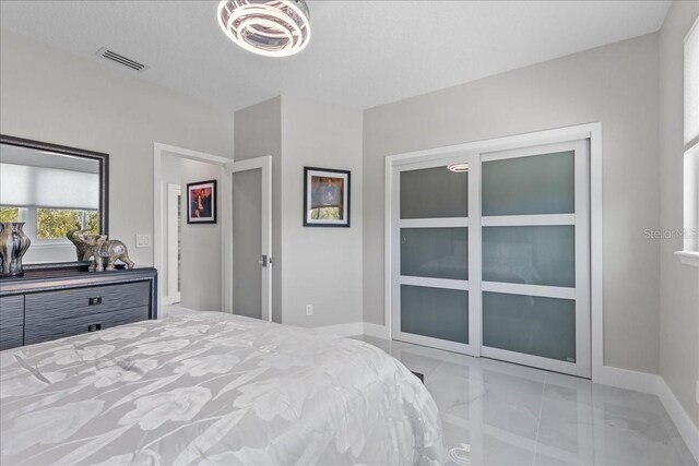 bedroom featuring visible vents, marble finish floor, and baseboards