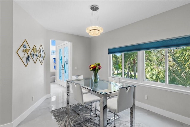 dining area with baseboards and a chandelier