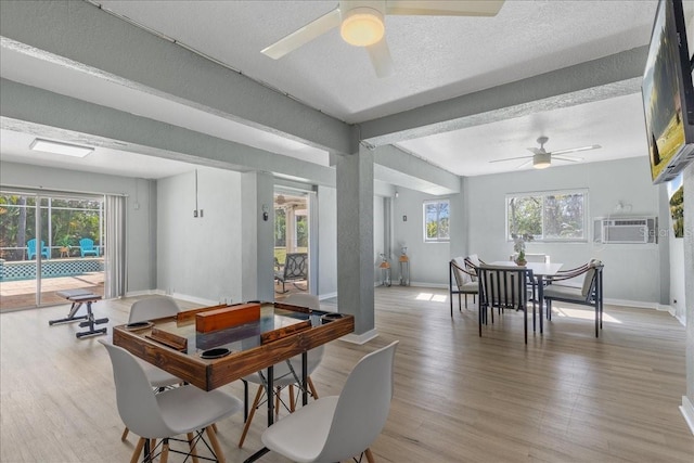 dining space featuring ceiling fan, plenty of natural light, a textured ceiling, and light wood-style flooring