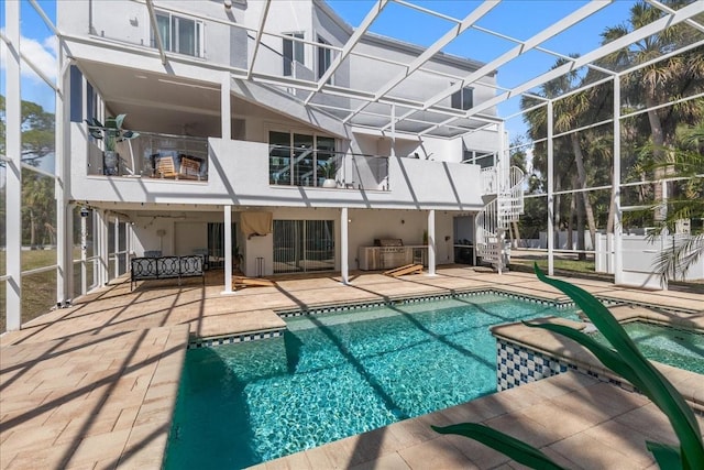 view of swimming pool with a patio area, glass enclosure, and a fenced in pool