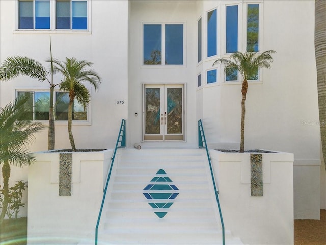 entrance to property with french doors and stucco siding