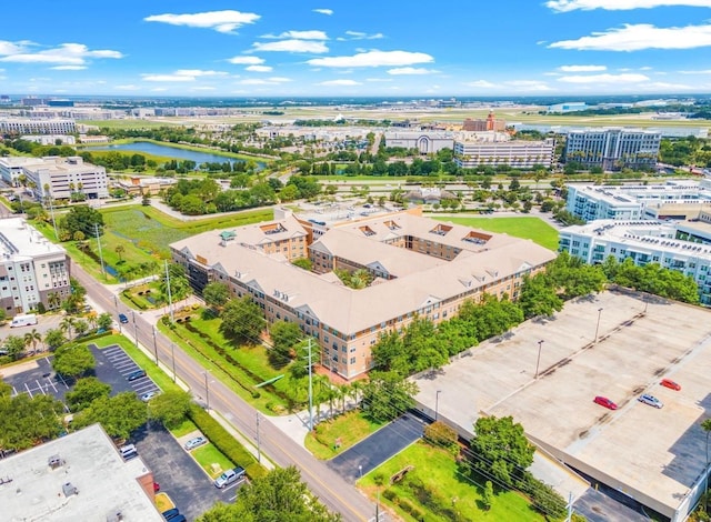 birds eye view of property featuring a water view and a view of city