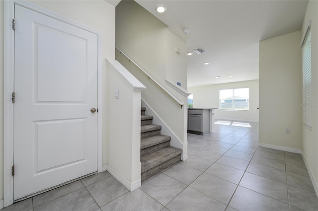 stairway with tile patterned flooring, visible vents, baseboards, and recessed lighting