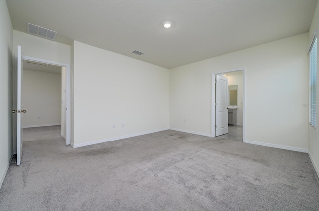 unfurnished bedroom with carpet, visible vents, and baseboards