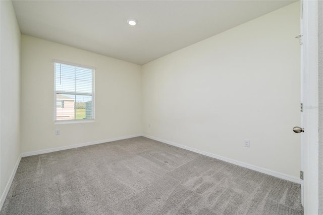 carpeted spare room with baseboards