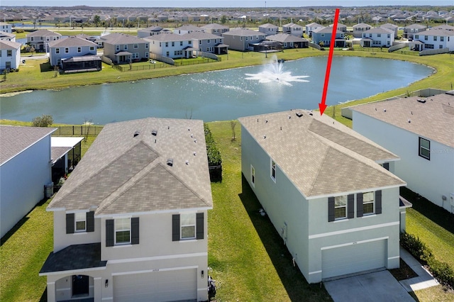 bird's eye view featuring a water view and a residential view