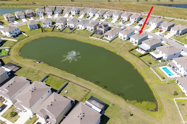 drone / aerial view with a water view and a residential view