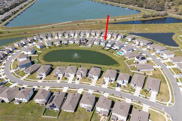 birds eye view of property with a residential view and a water view