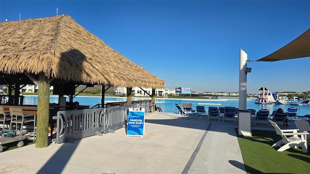 view of home's community with a water view and a gazebo