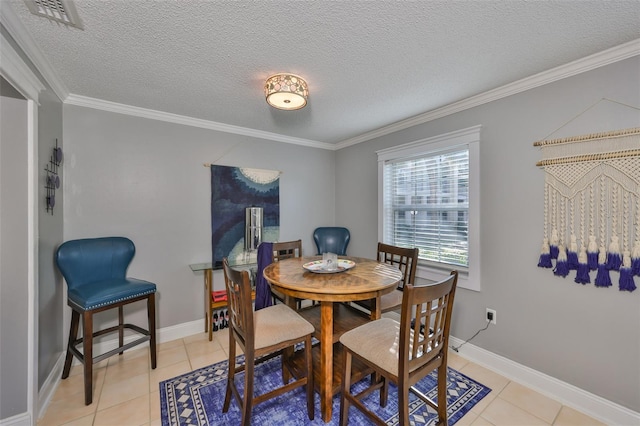 dining room featuring light tile patterned floors, ornamental molding, and visible vents