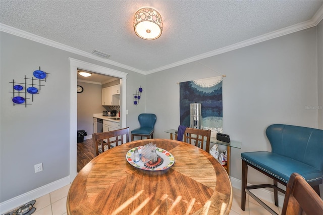 dining area featuring visible vents, crown molding, a textured ceiling, and light tile patterned floors