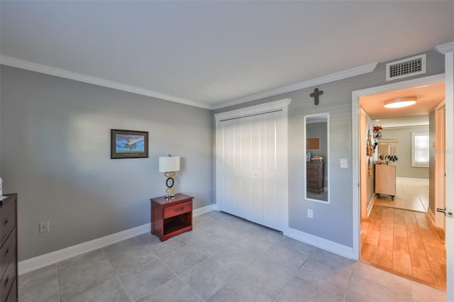 bedroom featuring baseboards, visible vents, and crown molding