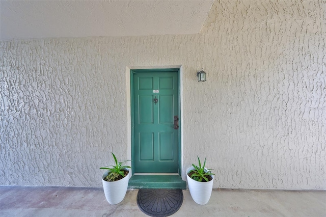 property entrance featuring stucco siding