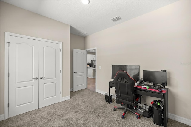 office area with visible vents, baseboards, and carpet