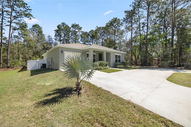 view of front of house featuring central AC unit, stucco siding, a front lawn, concrete driveway, and a garage