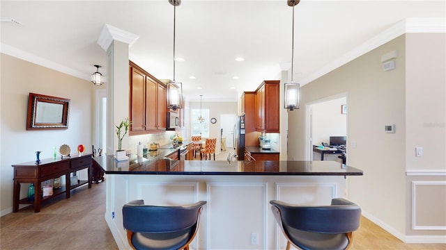 kitchen featuring ornamental molding, brown cabinetry, dark countertops, and decorative backsplash