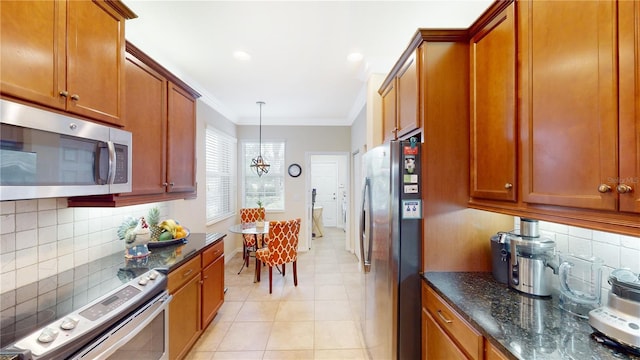 kitchen with appliances with stainless steel finishes, brown cabinets, crown molding, and hanging light fixtures