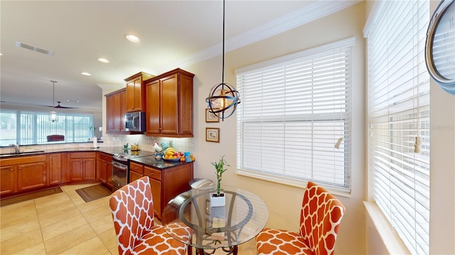 kitchen featuring crown molding, dark countertops, visible vents, backsplash, and appliances with stainless steel finishes