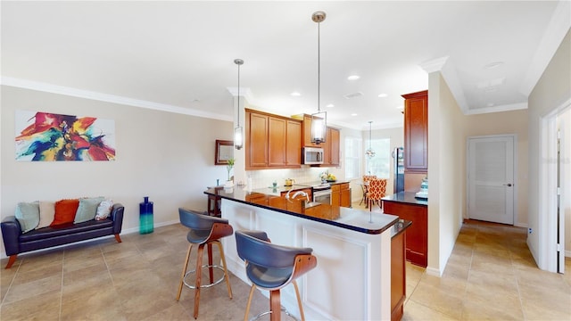 kitchen featuring dark countertops, stainless steel microwave, crown molding, fridge, and backsplash