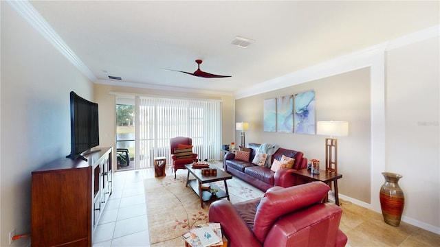 living area featuring ceiling fan, light tile patterned floors, visible vents, baseboards, and ornamental molding