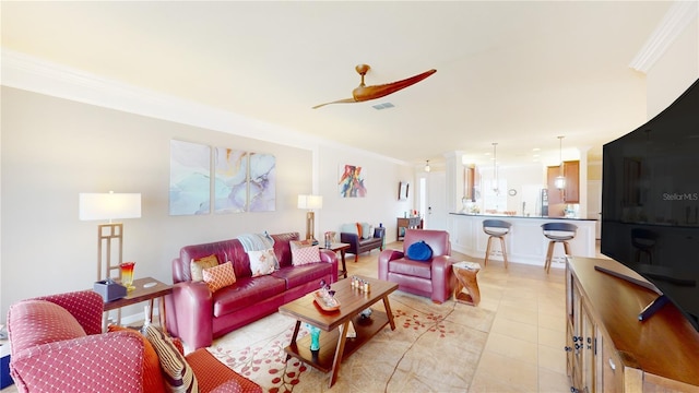 living area with ornamental molding, light tile patterned flooring, ceiling fan, and visible vents