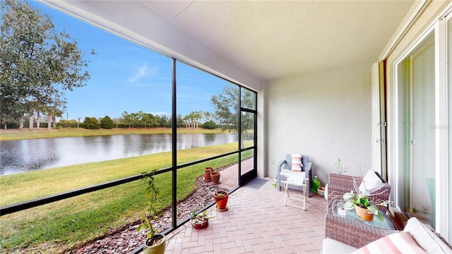 sunroom / solarium with a water view