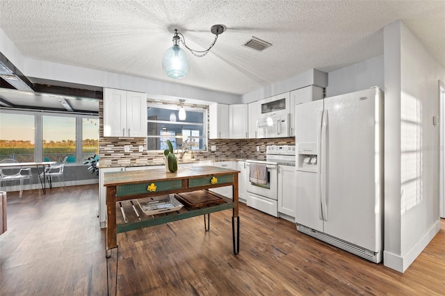 kitchen featuring white appliances, white cabinetry, dark wood finished floors, and decorative backsplash