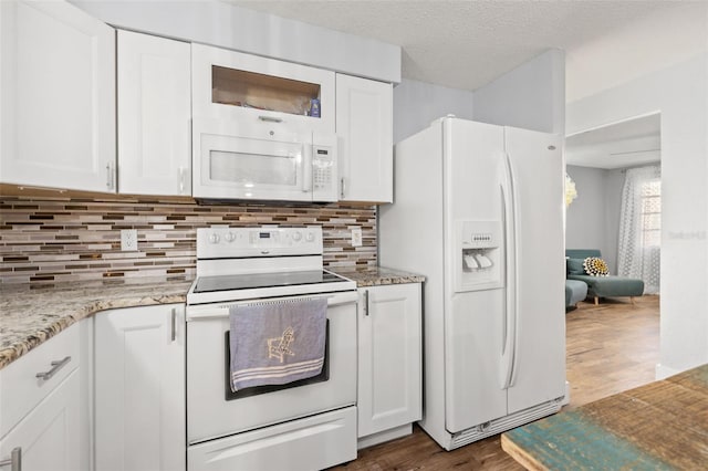 kitchen featuring dark wood-style floors, tasteful backsplash, white cabinets, a textured ceiling, and white appliances