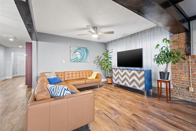 living area featuring ceiling fan, a textured ceiling, and wood finished floors